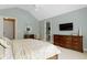 Charming primary bedroom featuring vaulted ceilings, a dresser, and access to the bathroom at 3965 Andretti Dr, Zionsville, IN 46077
