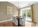 Dining room with hardwood floors, a chandelier and large glass door providing natural light at 3965 Andretti Dr, Zionsville, IN 46077