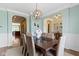 Inviting dining room with decorative light fixture, open archways, and modern decor at 3965 Andretti Dr, Zionsville, IN 46077