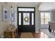 Welcoming entryway featuring a stylish front door, hardwood floors, and elegant decor at 3965 Andretti Dr, Zionsville, IN 46077