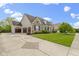 Attractive home with a long driveway, three-car garage and well-kept front lawn and landscaping at 3965 Andretti Dr, Zionsville, IN 46077