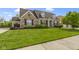 Beautiful stone home with well-maintained lawn and a welcoming front yard landscape at 3965 Andretti Dr, Zionsville, IN 46077