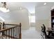 A carpeted upstairs hallway area with an office nook, decorative lighting, and neutral walls at 3965 Andretti Dr, Zionsville, IN 46077