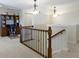 A second-floor hallway area showcasing a desk and chair with decorative lighting and carpet floors at 3965 Andretti Dr, Zionsville, IN 46077