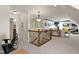 A hallway with wood and metal railing leads to a bonus room with blue accents and a TV at 3965 Andretti Dr, Zionsville, IN 46077