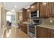 Kitchen features stainless steel appliances, granite countertops, and wooden cabinets at 3965 Andretti Dr, Zionsville, IN 46077