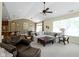 Open-concept living room with vaulted ceilings flowing into the dining area and a breakfast bar at 3965 Andretti Dr, Zionsville, IN 46077