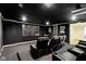 A home theater room with stadium seating, projector, and a large screen at 3965 Andretti Dr, Zionsville, IN 46077