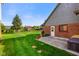 Spacious backyard with lush green grass, mature trees, and exterior view of brick home at 4316 Moss Ridge Cir, Indianapolis, IN 46237