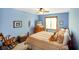 Cozy bedroom with a ceiling fan, comfortable bedding, and natural light from the window at 4316 Moss Ridge Cir, Indianapolis, IN 46237