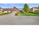 Traditional brick home with a well-kept lawn, mature tree, and a paved driveway leading to an attached garage at 4316 Moss Ridge Cir, Indianapolis, IN 46237