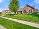 Attractive brick home showcasing a well-maintained lawn and a mature tree, complemented by a paved walkway at 4316 Moss Ridge Cir, Indianapolis, IN 46237