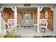 Inviting front porch featuring decorative chairs, a 'Welcome' sign, and a charming entrance to a brick home at 4316 Moss Ridge Cir, Indianapolis, IN 46237