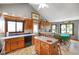 Bright kitchen with wooden cabinets, tile backsplash, and an island, with a dining area at 4316 Moss Ridge Cir, Indianapolis, IN 46237