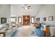 Spacious living room with vaulted ceilings, a cozy fireplace, comfortable seating, and abundant natural light at 4316 Moss Ridge Cir, Indianapolis, IN 46237