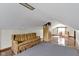 A simple attic room features hardwood floors, gray carpeting, and a couch at 46 N Kitley Ave, Indianapolis, IN 46219