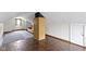 This attic has hardwood floors and gray carpeting, split by a column at 46 N Kitley Ave, Indianapolis, IN 46219