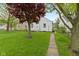 Backyard with healthy green grass and a view of the exterior of the home at 46 N Kitley Ave, Indianapolis, IN 46219