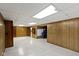 Large basement featuring wood paneling and a decorative fireplace at 46 N Kitley Ave, Indianapolis, IN 46219