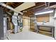 Unfinished basement featuring mechanicals, workbench and shelving at 46 N Kitley Ave, Indianapolis, IN 46219