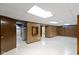 Spacious basement featuring wood paneling and a tile floor at 46 N Kitley Ave, Indianapolis, IN 46219
