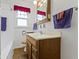 This bathroom features a single sink, a medicine cabinet, and a window at 46 N Kitley Ave, Indianapolis, IN 46219