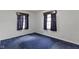 Empty bedroom with blue carpeting and large windows at 46 N Kitley Ave, Indianapolis, IN 46219