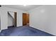 A simple bedroom features blue carpeting, a closet, and a white walls at 46 N Kitley Ave, Indianapolis, IN 46219