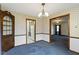 Spacious dining room with vintage light fixture and a view into the kitchen at 46 N Kitley Ave, Indianapolis, IN 46219