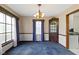 Dining room with vintage chandelier and patterned wallpaper at 46 N Kitley Ave, Indianapolis, IN 46219