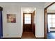 Welcoming entryway featuring a dark wood door, and a vibrant red-tiled floor at 46 N Kitley Ave, Indianapolis, IN 46219
