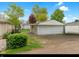 Detached two car garage with a gated chain link fence and mature landscaping in a residential neighborhood at 46 N Kitley Ave, Indianapolis, IN 46219
