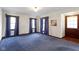 Traditional living room with blue carpeting and original woodwork provides a cozy, classic feel at 46 N Kitley Ave, Indianapolis, IN 46219