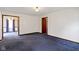Spacious living room featuring hardwood trim and blue carpeting at 46 N Kitley Ave, Indianapolis, IN 46219