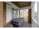 Relaxing porch area with striped seating, brick accents, and natural wood ceiling at 46 N Kitley Ave, Indianapolis, IN 46219