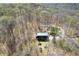 Secluded cabin with a green metal roof surrounded by beautiful trees and lush landscaping at 4840 N Templin Rd, Martinsville, IN 46151