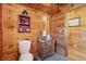 Cozy half bathroom features wood paneled walls and a toilet at 4840 N Templin Rd, Martinsville, IN 46151