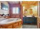 Relaxing bathroom with double sinks, vanity, and jacuzzi tub under the window at 4840 N Templin Rd, Martinsville, IN 46151