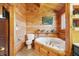 Comfortable bathroom featuring a toilet, jacuzzi tub, and painted landscape picture at 4840 N Templin Rd, Martinsville, IN 46151
