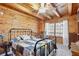 Bedroom featuring wood walls, a ceiling fan, and a window with lots of natural light at 4840 N Templin Rd, Martinsville, IN 46151