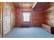 Wood-paneled bedroom featuring cozy carpeting, natural light, and ample closet space, a relaxing space at 4840 N Templin Rd, Martinsville, IN 46151