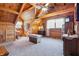 A cozy bedroom featuring wood paneling, beamed ceilings, and a ceiling fan at 4840 N Templin Rd, Martinsville, IN 46151