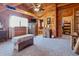 Bedroom with wood walls, ceiling fan, and view to an adjoining room with a bathroom at 4840 N Templin Rd, Martinsville, IN 46151