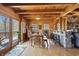 Bright dining room boasts wood paneled walls, ceilings, hardwood floors, and a view of the stone fireplace at 4840 N Templin Rd, Martinsville, IN 46151