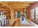Charming dining room features a wooden table with a view of the rustic interior and kitchen at 4840 N Templin Rd, Martinsville, IN 46151