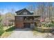 Stunning two-story log home featuring a covered porch, garage, and serene wooded surroundings at 4840 N Templin Rd, Martinsville, IN 46151