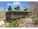 Beautiful log cabin with a covered porch and a green metal roof nestled in a wooded area at 4840 N Templin Rd, Martinsville, IN 46151