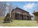 A multi-level log cabin home with wooden decks, a walkout basement and yard at 4840 N Templin Rd, Martinsville, IN 46151