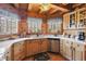 Charming kitchen boasts wood paneled walls, white countertops, and stainless steel appliances at 4840 N Templin Rd, Martinsville, IN 46151