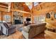 Cozy living room with a stone fireplace, wood paneling, comfortable seating, and bright windows at 4840 N Templin Rd, Martinsville, IN 46151